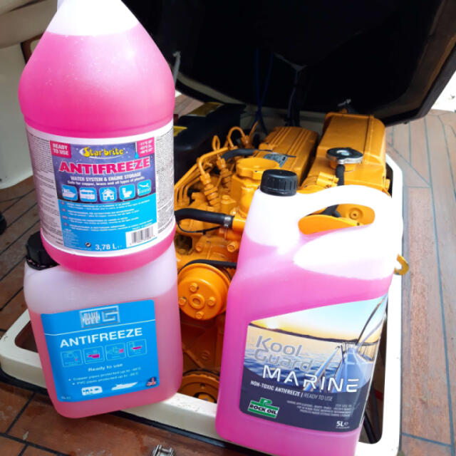 Antifreeze bottles in front of a boat engine.