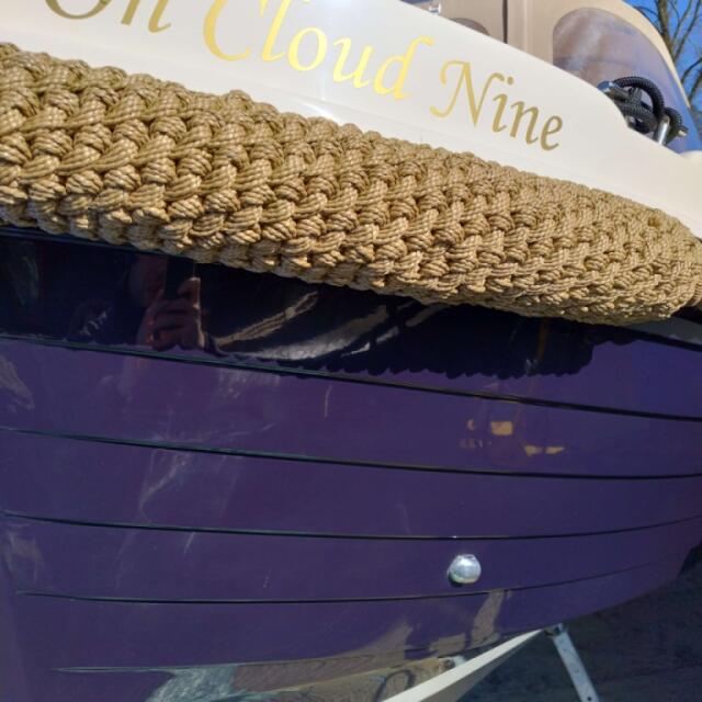 A close up of a boat having been cleaned and polished to a high gloss shine.