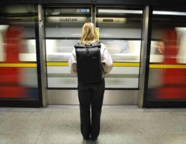 A women with the black OverBoard Backpack commuting to work on the London Underground